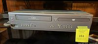 Front view of Magnavox combo player showing VHS slot, DVD tray, controls and model marking