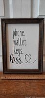 Front view of framed canvas sign showing full text and ruler for scale