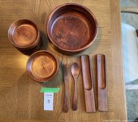Full set showing large bowl, small bowls stack, fork, spoon, tong halves