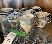 Group view of teacups stacked with saucers