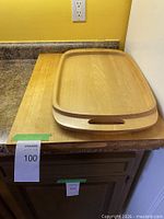 Both wooden boards on counter, butcher block beneath serving tray