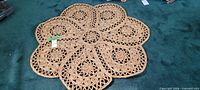 Full view of round six-petal jute mat on floor