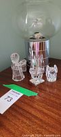 Front view of three crystal figurines and candle holder