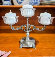 front view of candelabra with glass cups and candles