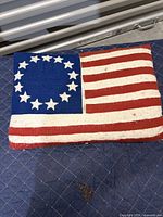 Front view showing Betsy Ross flag design and stains