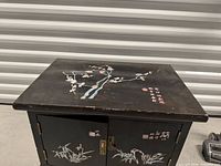 top view showing floral inlay and overall cabinet shape