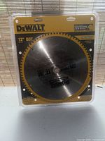 Front view of sealed DeWALT 12 in 80T fine finish blade in packaging