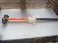 Full view of sledgehammer on table