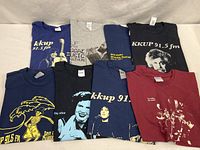 All eight KKUP t-shirts laid out for overview