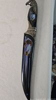Full view of knife showing handle artwork and sheath area