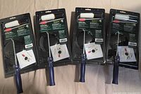 All four sealed paint roller kits laid out side by side