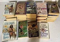 Stacked view of books showing several titles and spine condition