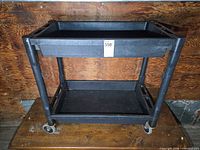 Full view of utility cart showing both tiers and casters