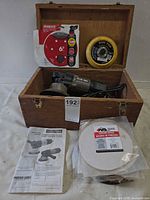 Entire lot in wooden case including sander, discs, pad and manual