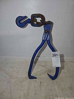 Full view of blue steel log tongs standing upright