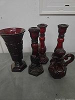 Group shot of all five Avon ruby red hobnail glass pieces