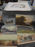 Overall view of portfolio contents on table, multiple prints visible