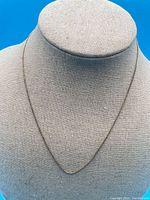 Necklace displayed on bust to show overall length and form