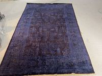 Full view of blue oriental rug showing overall design and wear