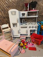 Entire play kitchen setup with accessories on floor