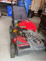 Front left view of Troy-Bilt T466 mower showing deck, engine cover and wheels