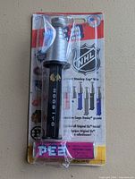 Front of sealed Pez dispenser showing Stanley Cup top, Blackhawks logo, 2009-10 text, NHL card backing