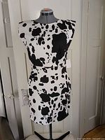 Front view of cow-print mini dress on mannequin