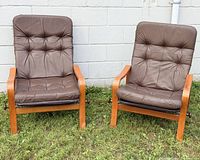 Front view of both lounge chairs showing frames, cushions, overall condition