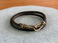 Full view of braided leather wrap bracelet coiled showing clasp