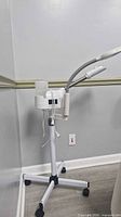 Full view of facial steamer showing base, main unit, hose, lamp, water reservoir