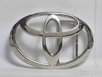 Front view of silver-tone Toyota logo belt buckle