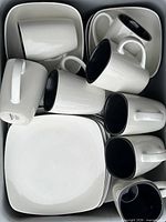 Top view of set showing stacked square plates and mugs