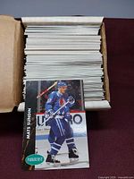 Box filled with large stack of 1991 Parkhurst hockey cards, Mats Sundin rookie card displayed in front