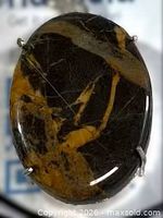Front view of oval coconut jasper pendant in silver-plated setting
