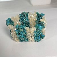 Angled view showing overall cuff shape, turquoise and white chip beads