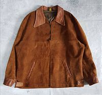 Front view of brown suede jacket with leather collar, pockets and side tabs