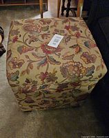 Full view of ottoman top and sides with floral upholstery