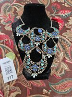 Full view of bib necklace on stand
