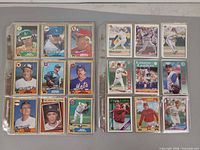 Two plastic sheets showing 18 cards each, mix of Topps and Fleer 1980s-1990s