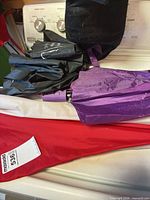 All three folded umbrellas showing colors and materials