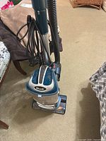 Full view of assembled Shark upright vacuum showing body, hose and cord