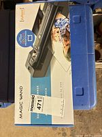 Boxed VuPoint Magic Wand handheld scanner on blue surface