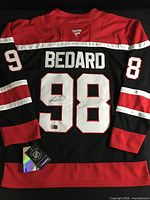 Full back view showing name BEDARD, number 98 and autograph, hangtag visible