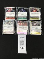 Six plastic-wrapped bundles of One Piece trading cards labelled OP15 Adventures on Whiskey Island