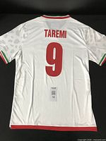 Back view showing TAREMI name, number 9, collar and sleeve trim