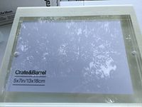 Front view of clear acrylic Crate & Barrel 5x7 frame showing insert and thickness