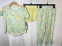 Three-piece pajama set displayed: top, shorts, pants