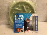 Slow feeder bowl and FurViking hair remover still packaged