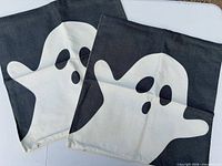 Front view of both pillow covers showing ghost design