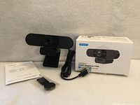 Front view of EMEET SmartCam C960 webcam with cable, clip, manual and box